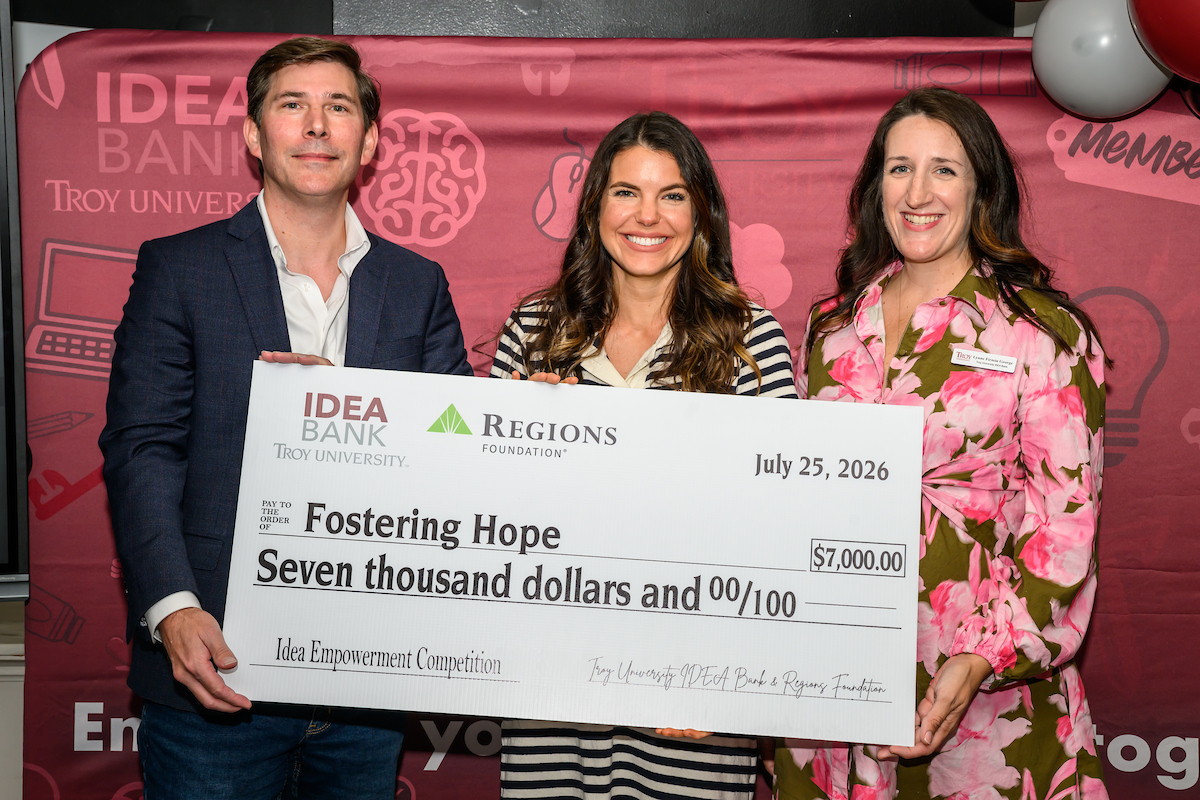 Woman holding big check for $7,000