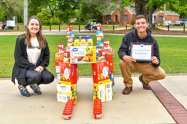 Winners of can castlr posing with their castle.