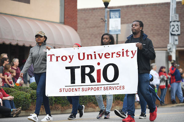 TRIO Students walking with a banner in a parade