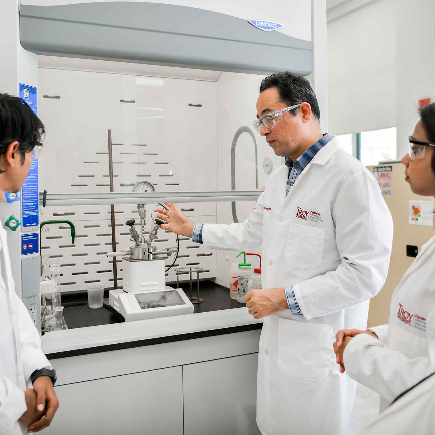 Professor working with students in a lab