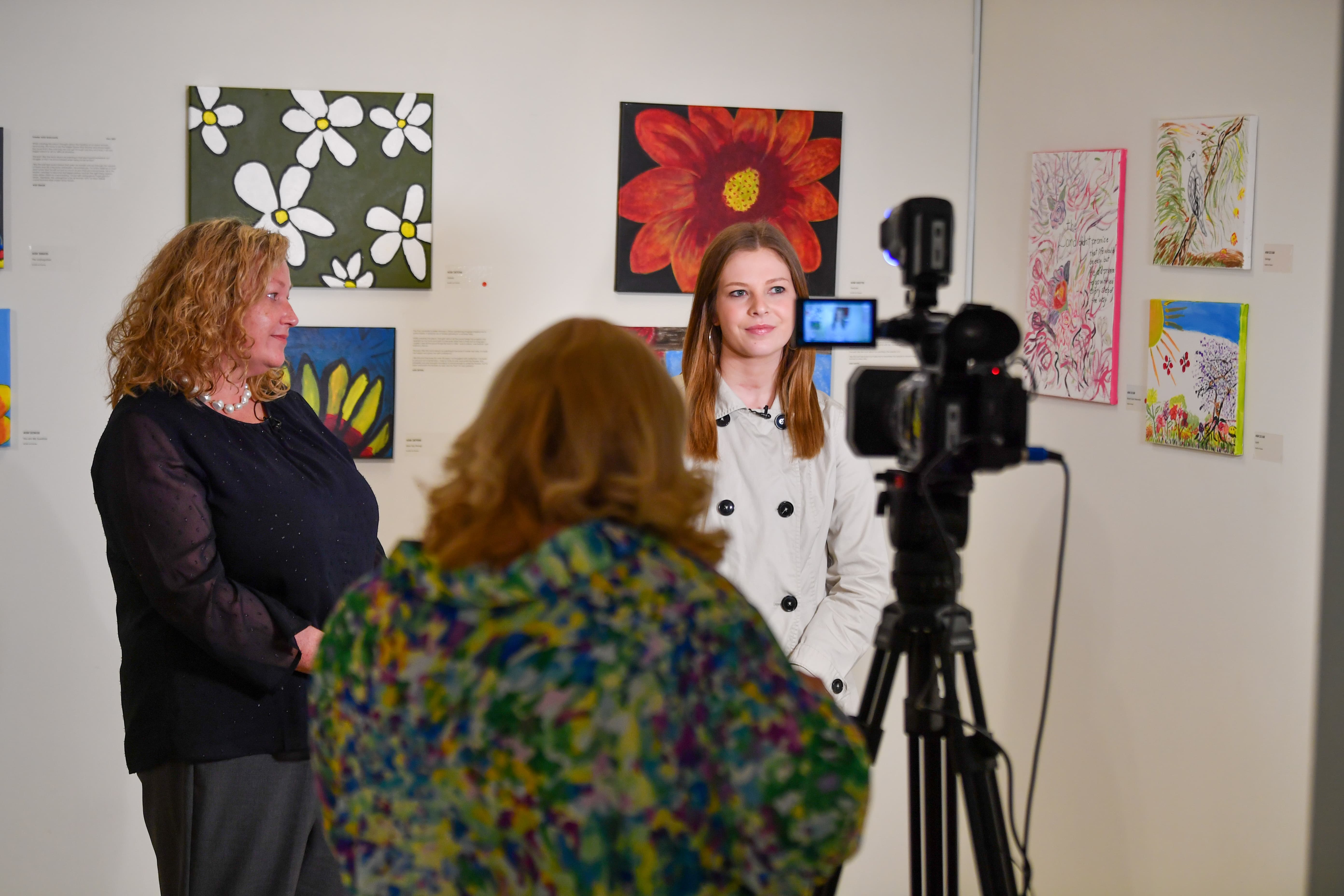 Troy University student recording a news segment during an event on campus. 