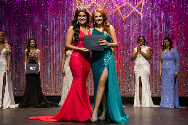 Grace Shellhouse is the Fitness Winner of Miss Troy 2025. She is receiving the award from Sara Jane Houston, Miss Troy University 2024.