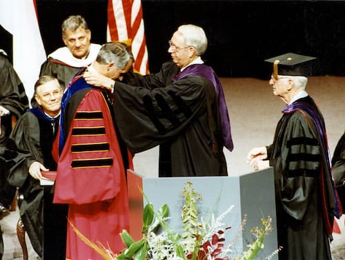 Alabama Gov. Guy Hunt drapes the Chancellor’s Medallion around the neck of Dr. Jack Hawkins, Jr. during inauguration ceremonies in 1989, with former Chancellor Dr. Ralph Adams, right, assisting.