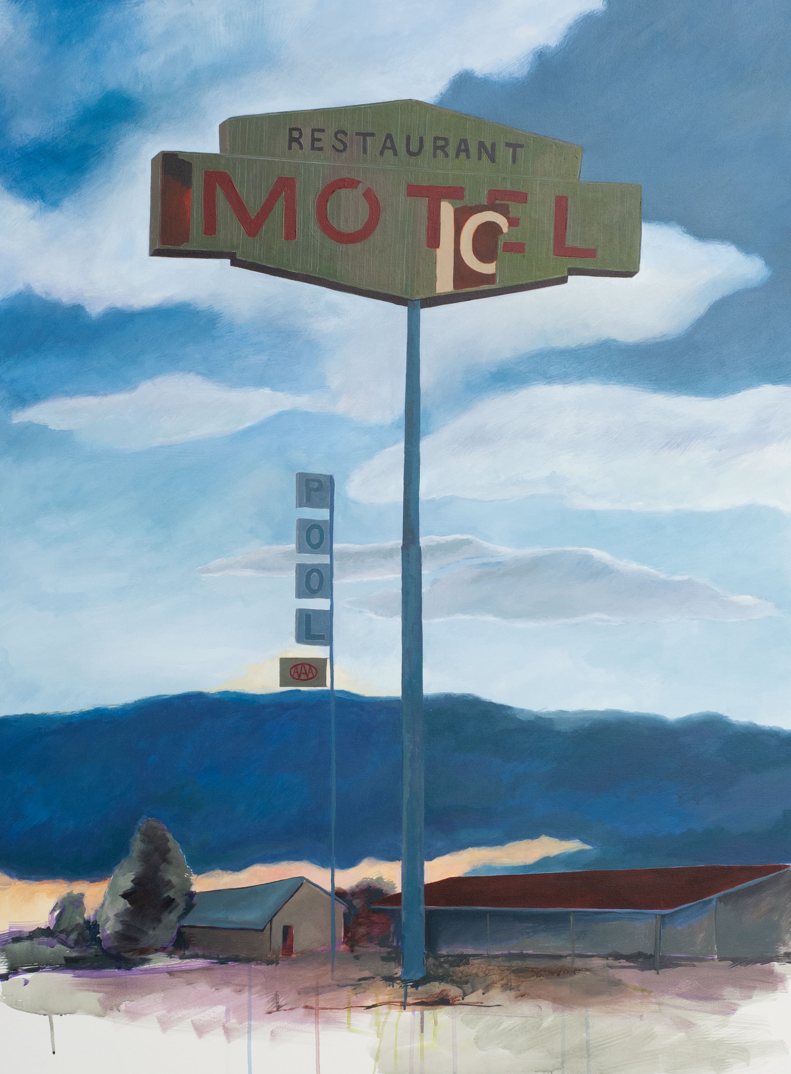 a dilapidated motel sign on a barren landscape