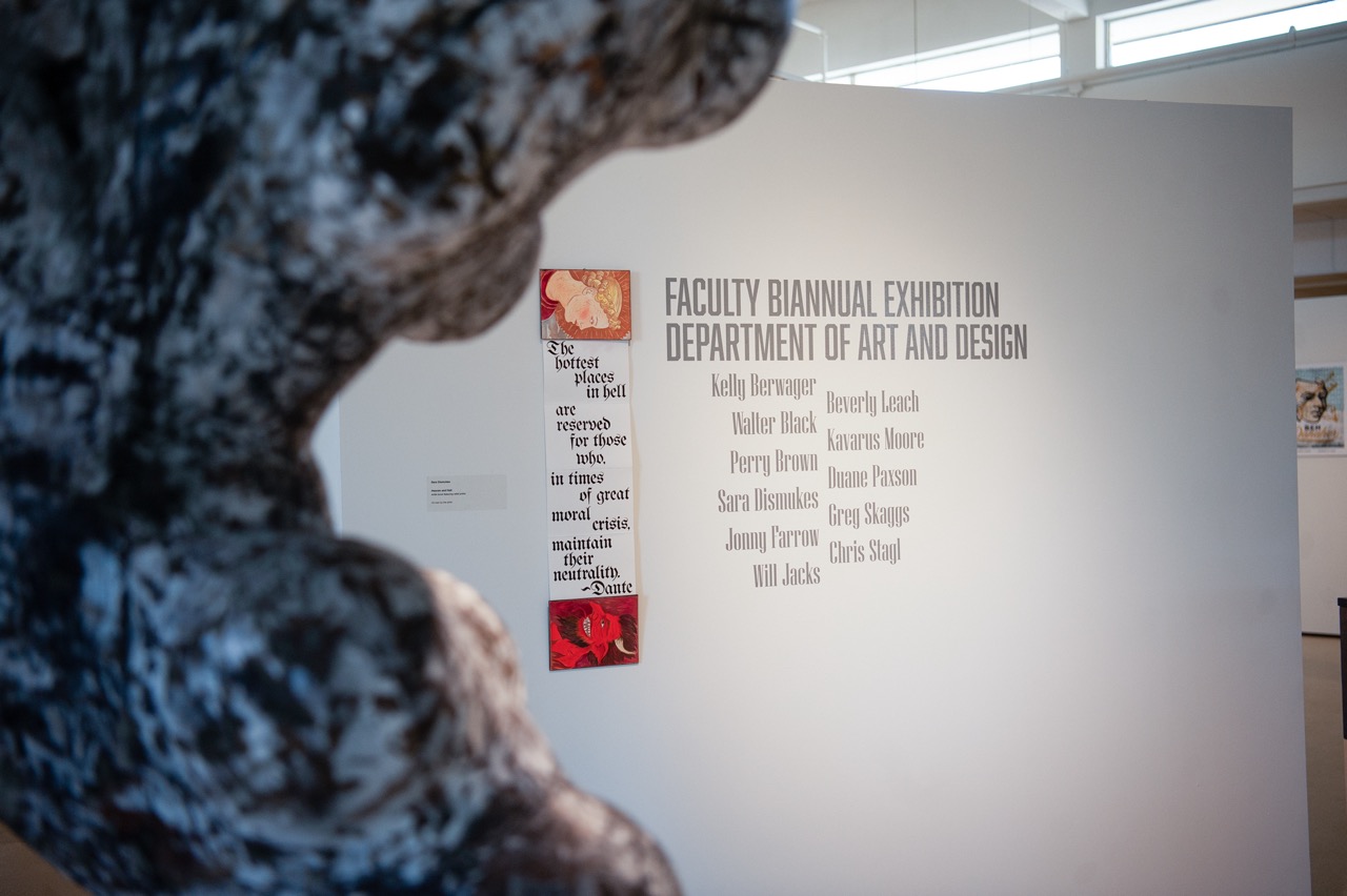 Vinyl treatment showing faculty show title behind sculpture