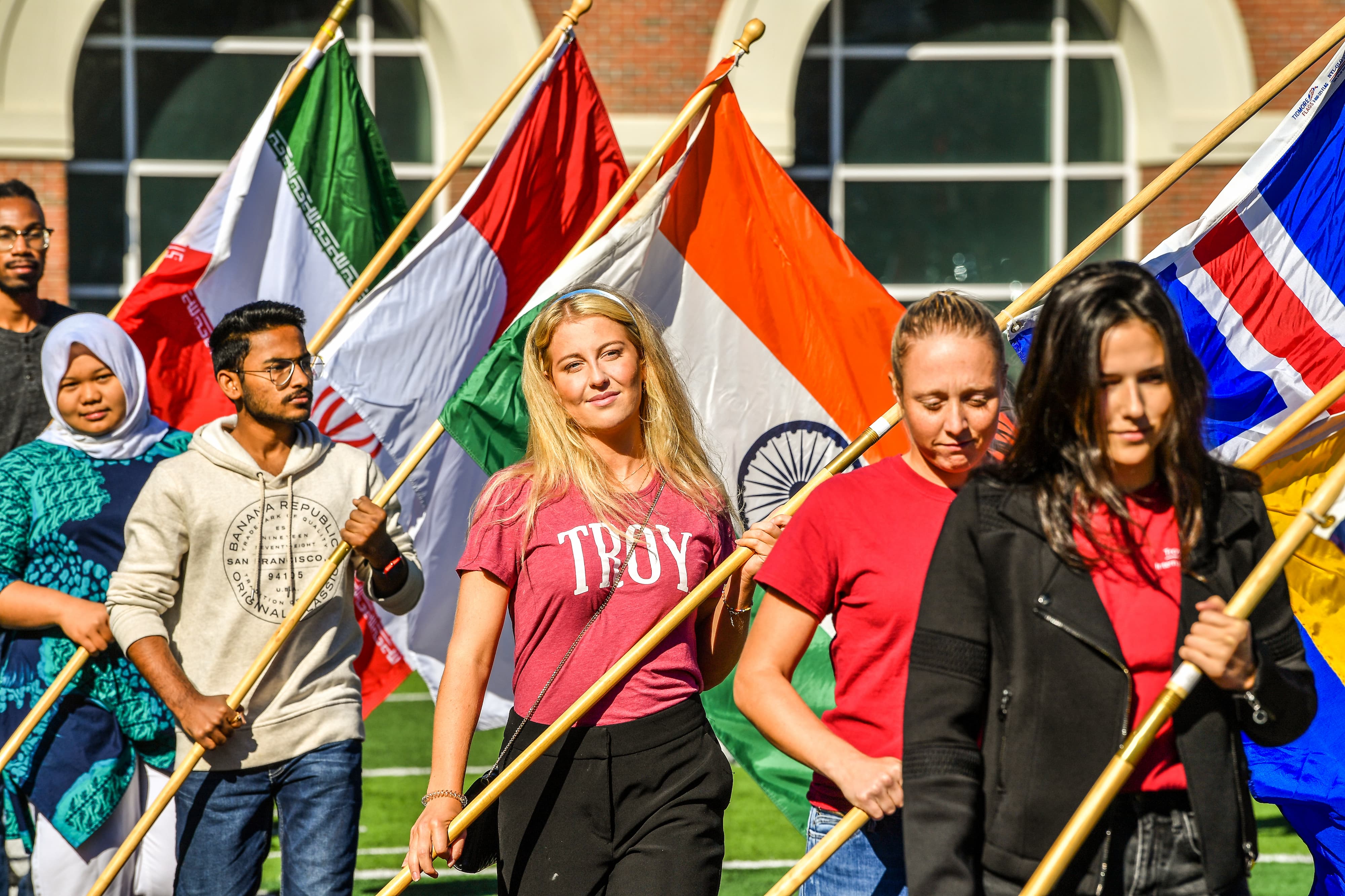 International students carrying their country's flag