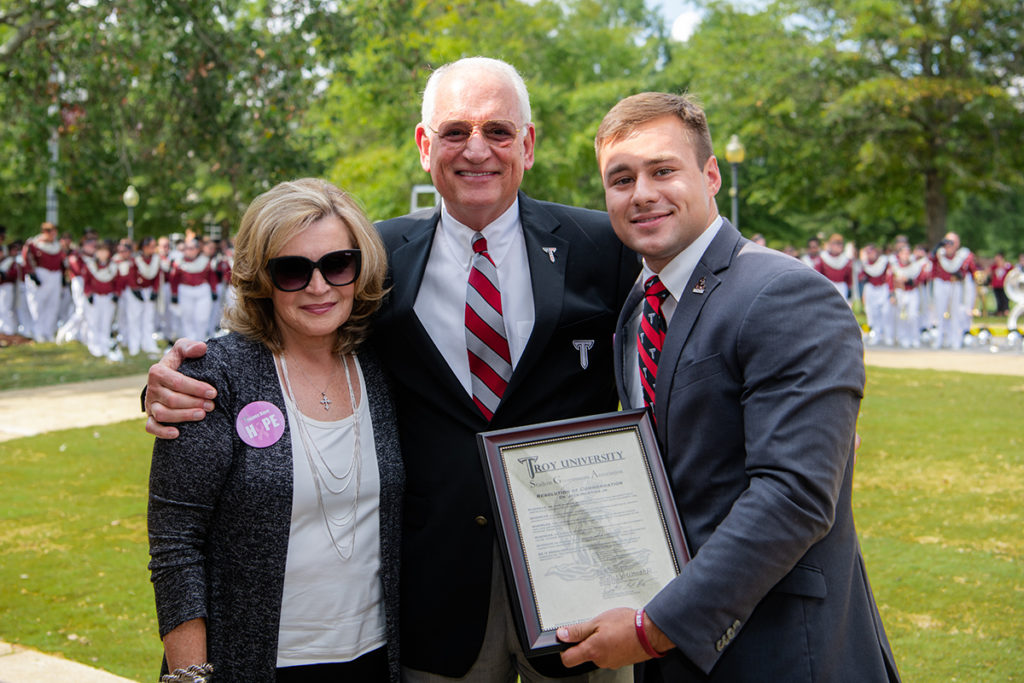 Morgan Long, Student Government Association president, presents Dr. and Mrs. Jack Hawkins, Jr. with a resolution honoring Dr. Hawkins’ 30th year as the University’s Chancellor.