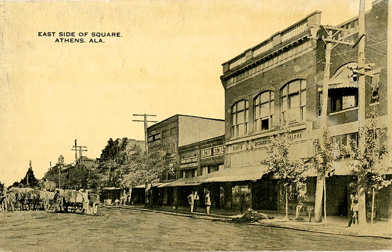 Black and white print of the town square and one and two-story commercial buildings in Athens, Alabama.