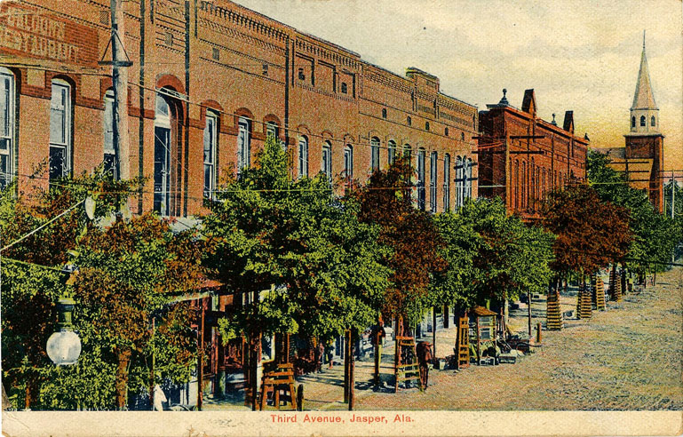 Color print of Third Avenue in Jasper, Alabama showing a row of red brick multi-story buildings. Postmarked August 31, 1908.