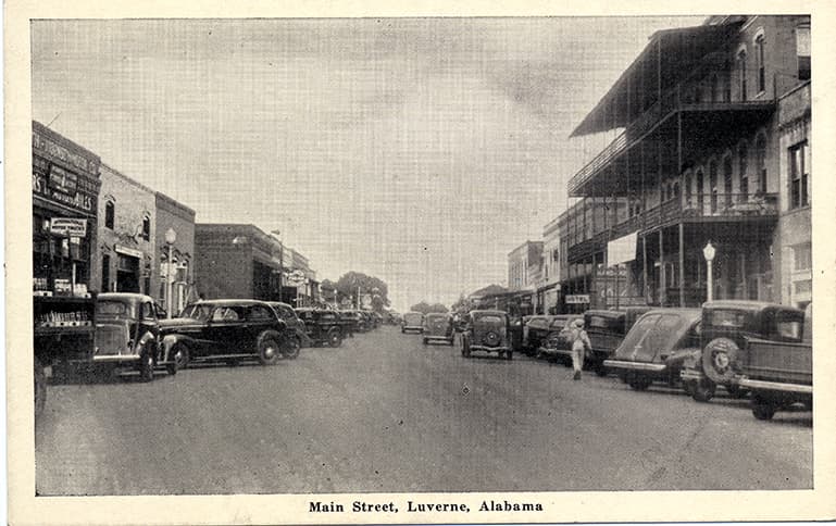 Black and white print of commercial buildings on Main Street in Luverne, Alabama.
