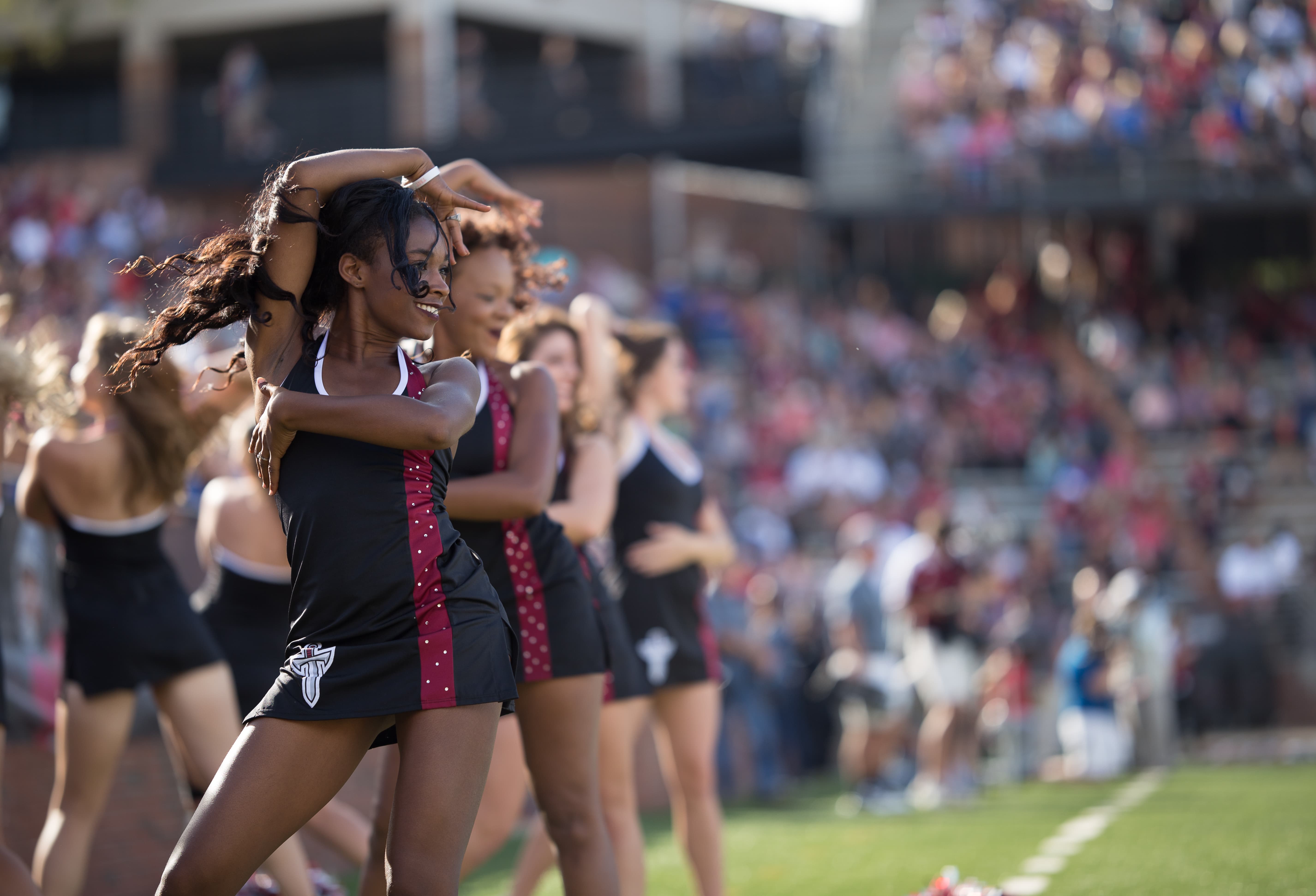 TROY cheerleaders performing on the field.