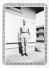 William Floyd standing outside Barracks 1901, location unknown, US Army snapshot in "Elko" paper frame, ca. 1942.