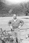 William Campbell, snapshot adjacent to fenced field with hills in background, US Army, location unknown, ca. 1942.