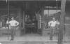 Grady and Coley McDaniel posing in front of the McDaniel Brothers Clothing and Shoe store on Broadway in Ashford, AL, ca. 1910s.